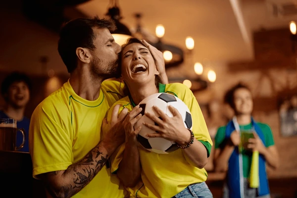 happy-couple-soccer-fans-celebrating-600nw-2498819839